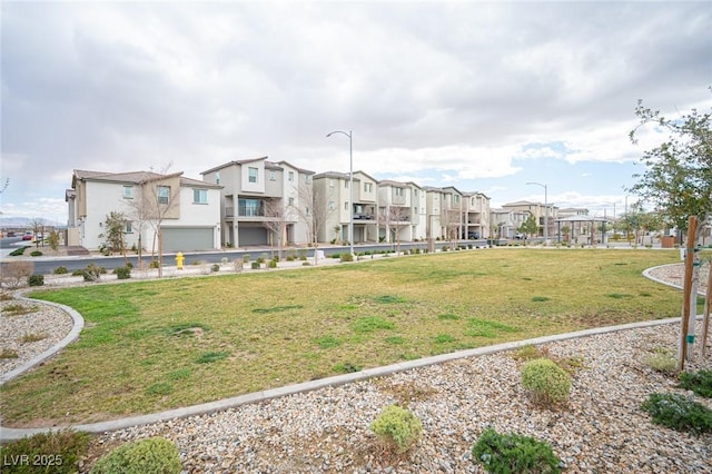 view of property's community with a residential view and a yard