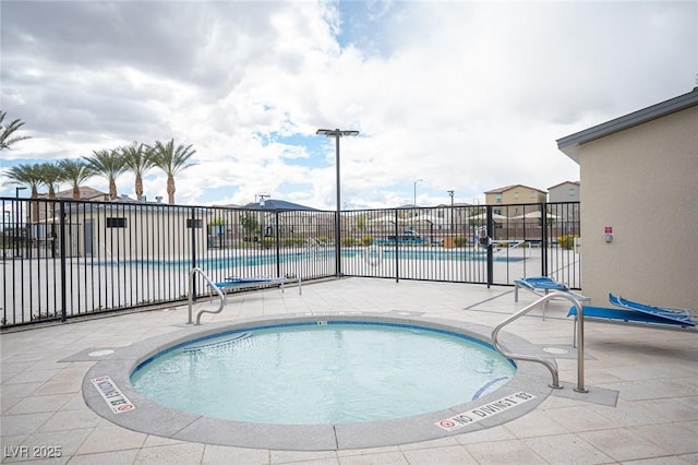 view of swimming pool featuring a patio area and fence