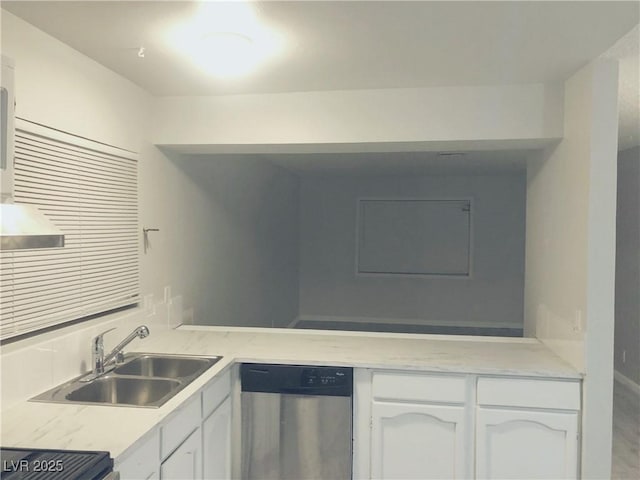 kitchen featuring stove, a sink, white cabinetry, light countertops, and stainless steel dishwasher