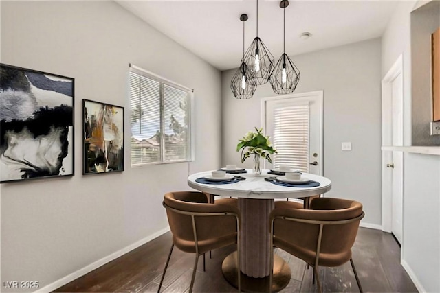 dining room featuring dark wood-type flooring and baseboards