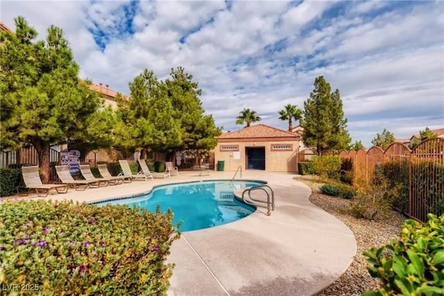 pool featuring a patio area and fence