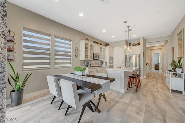 dining area with recessed lighting and baseboards