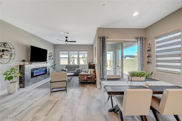 dining area featuring a fireplace, recessed lighting, visible vents, a ceiling fan, and baseboards