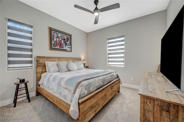 carpeted bedroom with a ceiling fan and baseboards