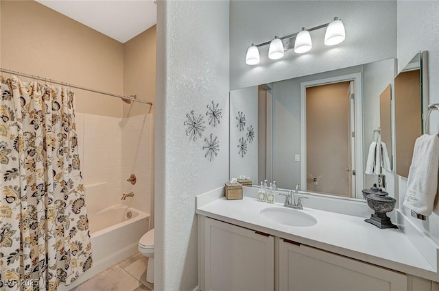 full bathroom featuring a textured wall, vanity, toilet, and shower / tub combo with curtain