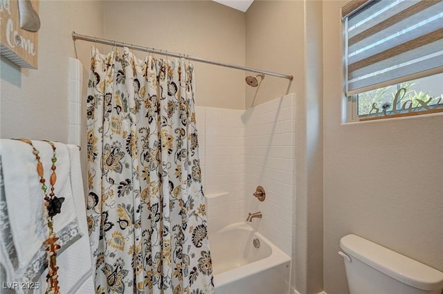 bathroom with shower / bath combination with curtain and toilet