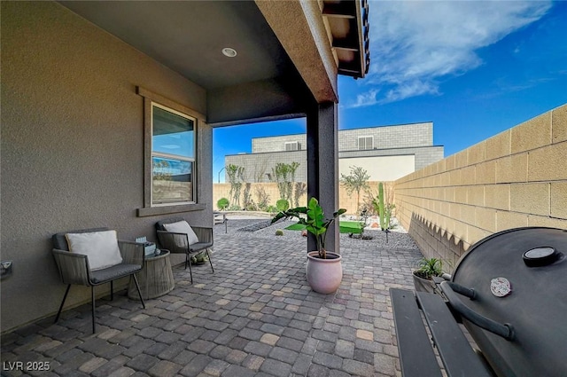 view of patio with a fenced backyard and grilling area