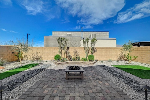 view of patio / terrace featuring an outdoor fire pit and a fenced backyard