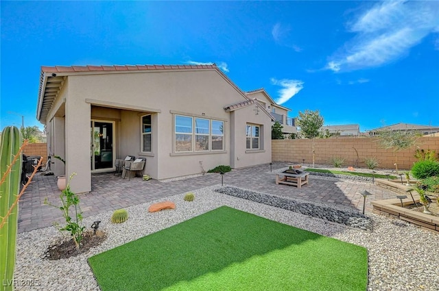 back of property with a patio, a fenced backyard, and stucco siding