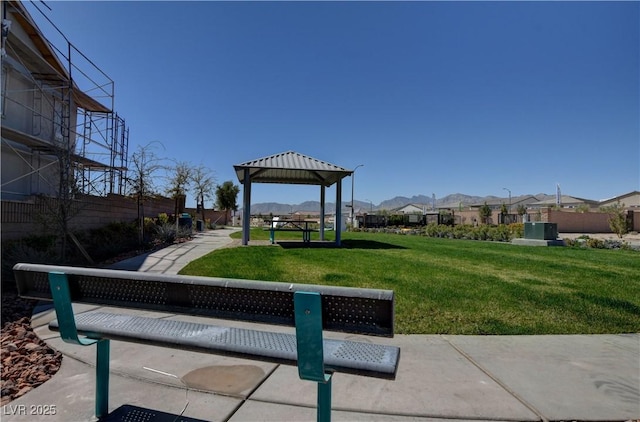 view of community with a mountain view, a lawn, and a gazebo