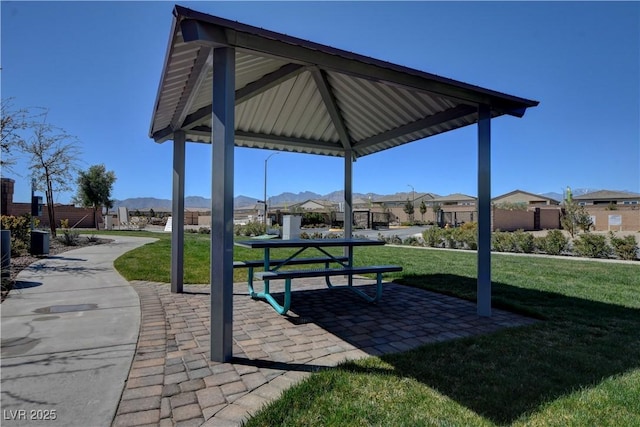 view of property's community featuring a patio area, a gazebo, a mountain view, and a yard