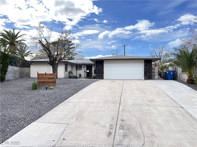 single story home featuring driveway, an attached garage, and fence