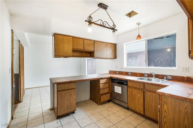 kitchen featuring brown cabinetry, dishwasher, a peninsula, and a sink