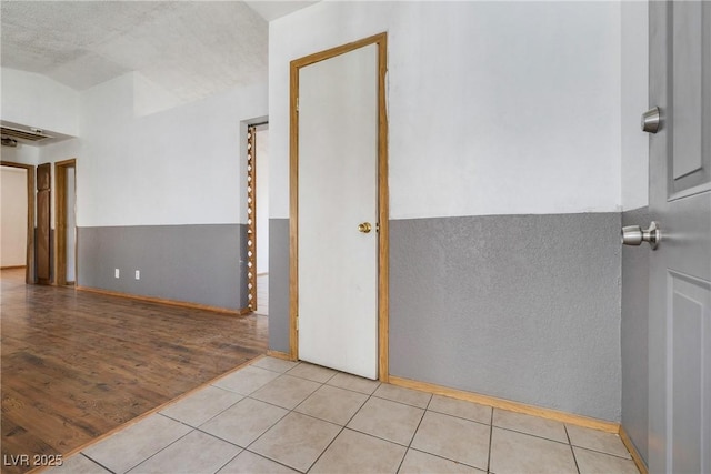 tiled empty room with vaulted ceiling