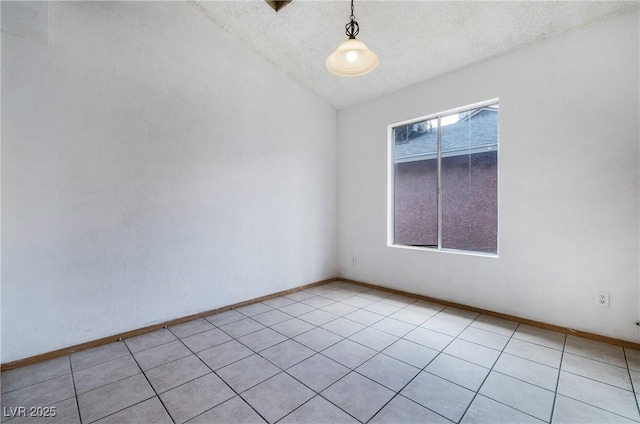 unfurnished room with lofted ceiling, baseboards, and a textured ceiling