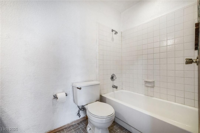 bathroom featuring bathtub / shower combination, toilet, and tile patterned flooring