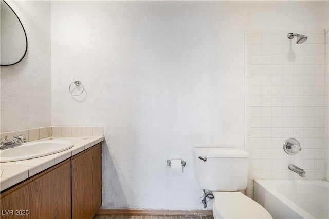 bathroom featuring shower / bathtub combination, toilet, and vanity