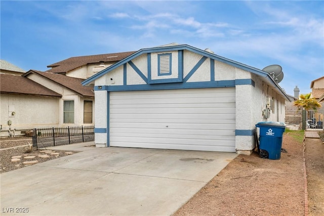 exterior space featuring a garage, driveway, and fence