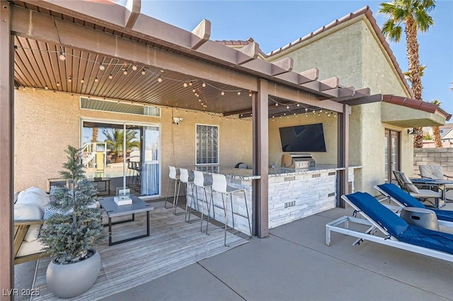 view of patio / terrace with outdoor wet bar and an outdoor kitchen