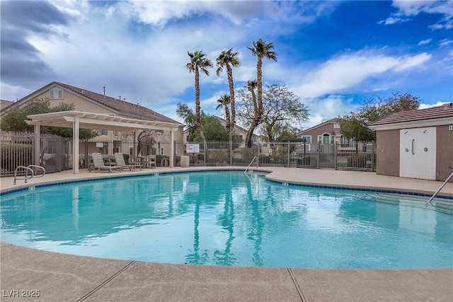 pool with a patio area, fence, and a pergola