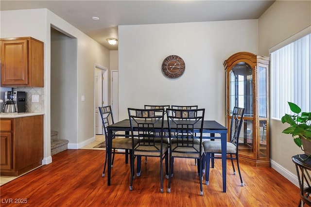 dining area featuring baseboards and wood finished floors