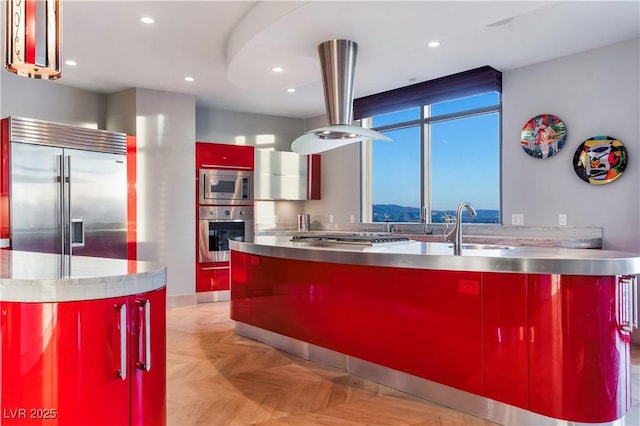 kitchen featuring built in appliances, stainless steel counters, modern cabinets, and recessed lighting