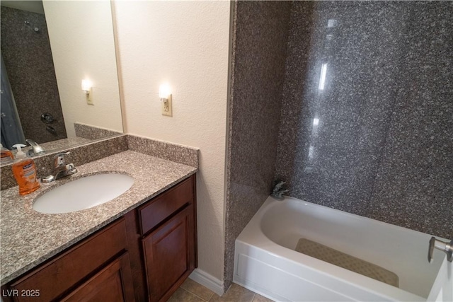 bathroom featuring washtub / shower combination, vanity, and tile patterned floors