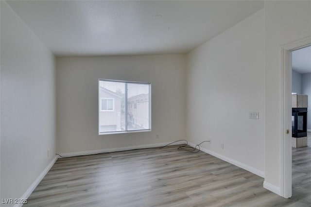 unfurnished room featuring baseboards and wood finished floors