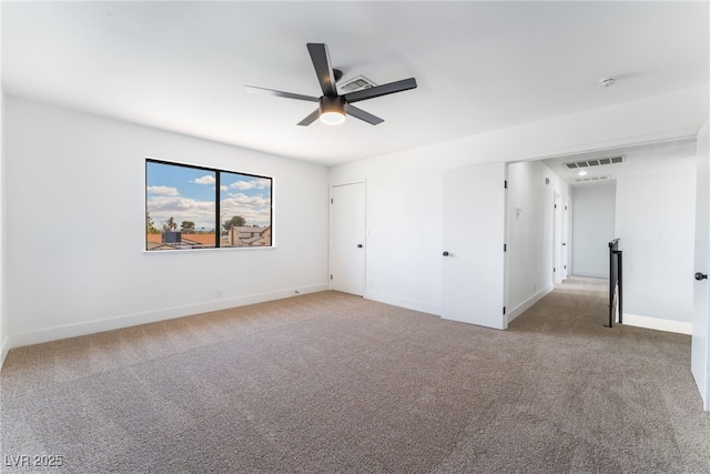 unfurnished bedroom with carpet, visible vents, and baseboards