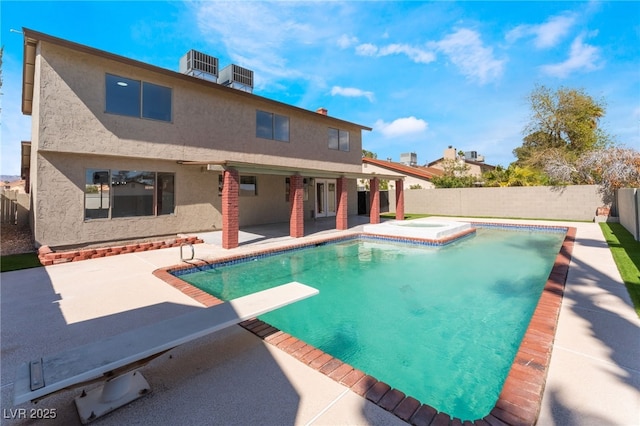 view of swimming pool featuring a diving board, a patio area, a fenced backyard, and a fenced in pool