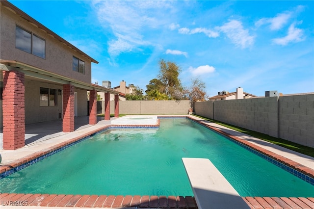 view of swimming pool with an in ground hot tub, a patio area, a fenced backyard, and a fenced in pool