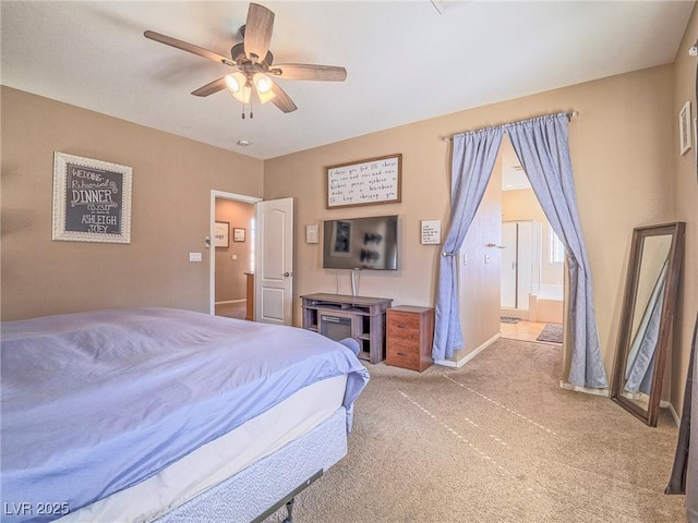 carpeted bedroom featuring ceiling fan, ensuite bath, and baseboards