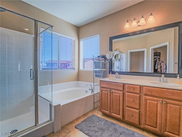 full bath featuring double vanity, a sink, a shower stall, and a bath