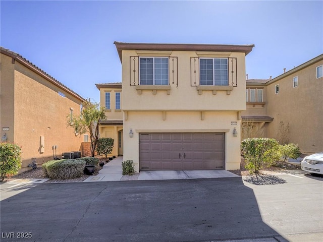 view of front facade featuring a garage, central AC, driveway, and stucco siding