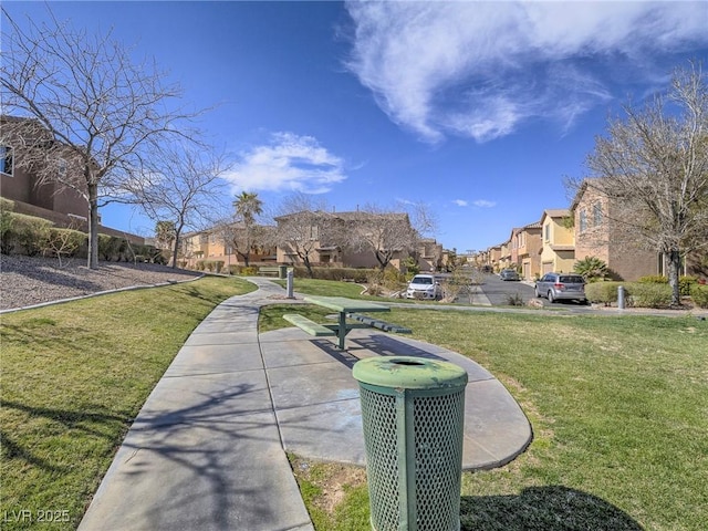 view of property's community featuring a residential view and a yard