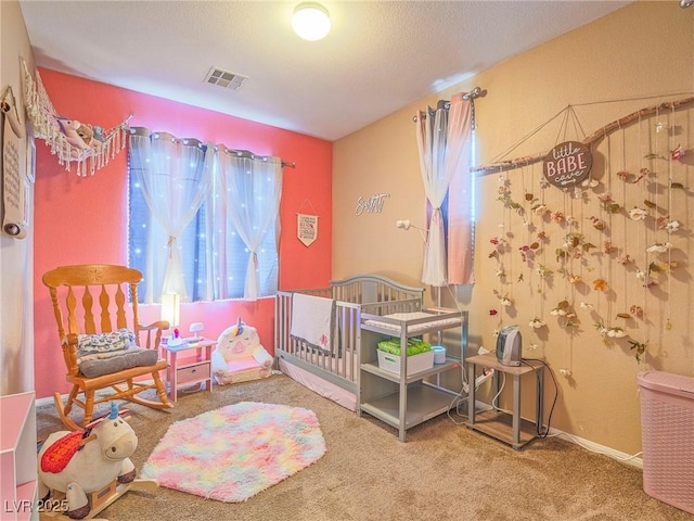 bedroom with visible vents and carpet flooring