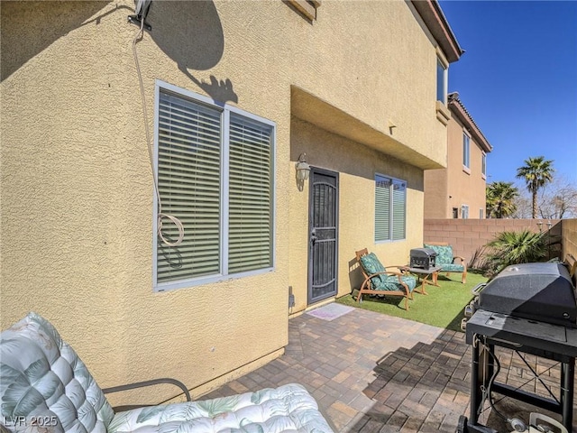 view of patio / terrace featuring grilling area and fence