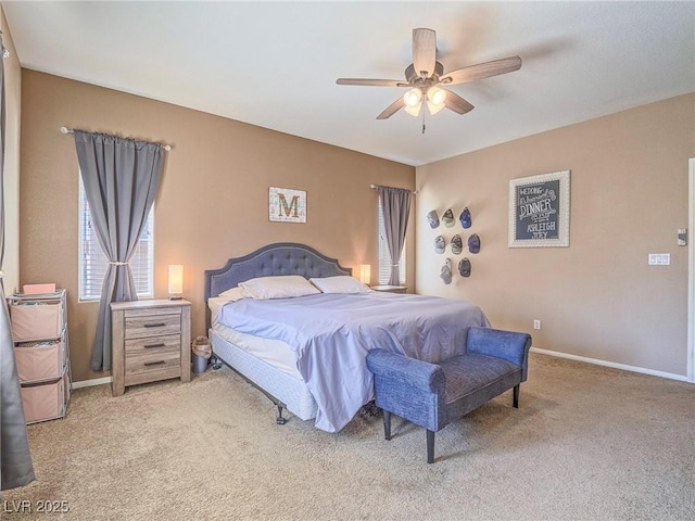 carpeted bedroom featuring baseboards and a ceiling fan