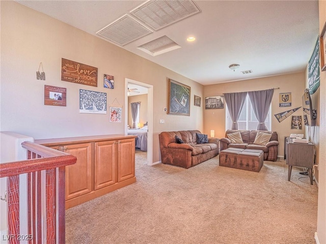 living area featuring light carpet, attic access, and visible vents