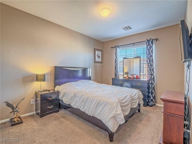 carpeted bedroom with visible vents and baseboards