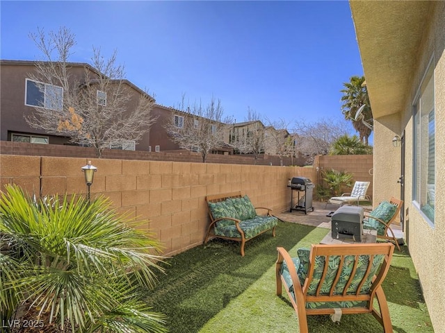 view of yard featuring a patio area and a fenced backyard