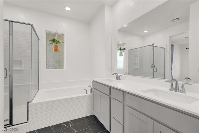 full bath with visible vents, a sink, a shower stall, and a garden tub