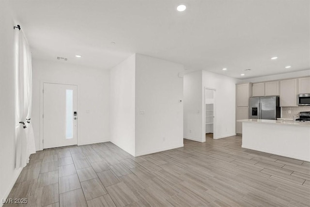 kitchen featuring visible vents, light wood-style flooring, stainless steel appliances, light countertops, and recessed lighting