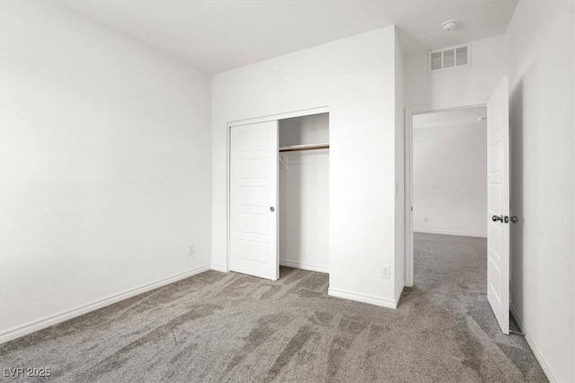 unfurnished bedroom featuring a closet, carpet, visible vents, and baseboards