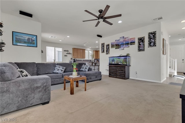 living room featuring light carpet, a ceiling fan, visible vents, and recessed lighting