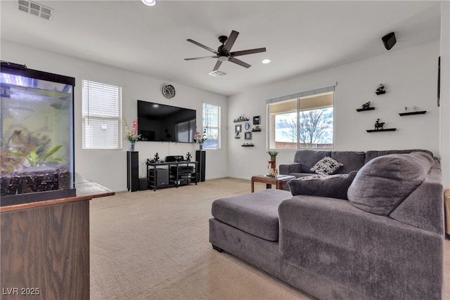 carpeted living room with ceiling fan, visible vents, baseboards, and recessed lighting