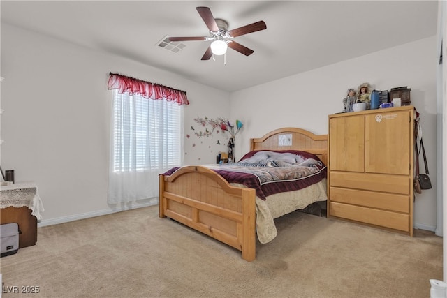 bedroom with baseboards, visible vents, a ceiling fan, and light colored carpet