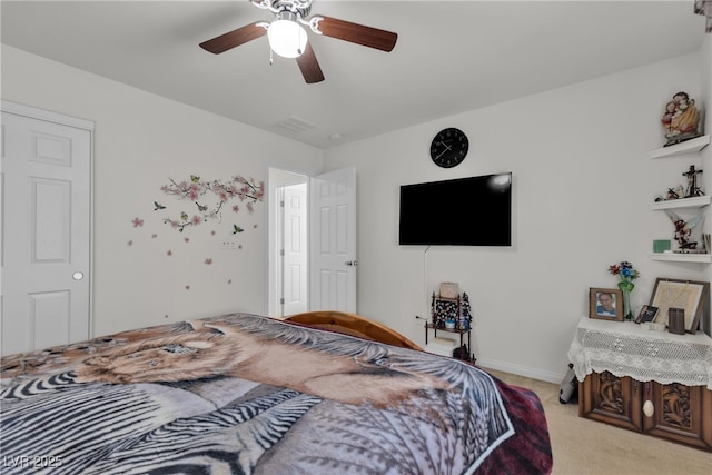 bedroom with light carpet, ceiling fan, and baseboards