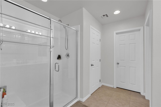 full bathroom with baseboards, tile patterned flooring, visible vents, and a shower stall