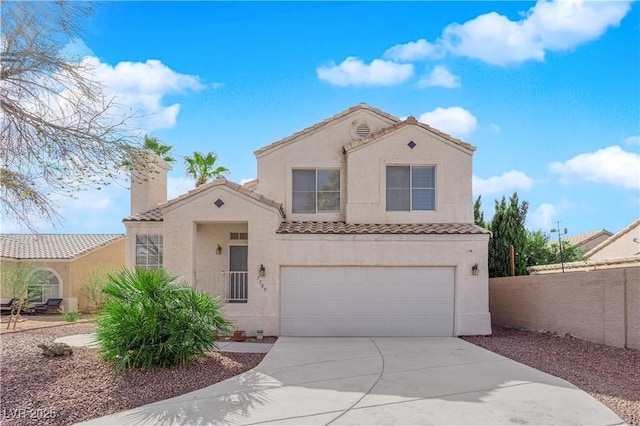 mediterranean / spanish-style home with driveway, a tile roof, a garage, and stucco siding